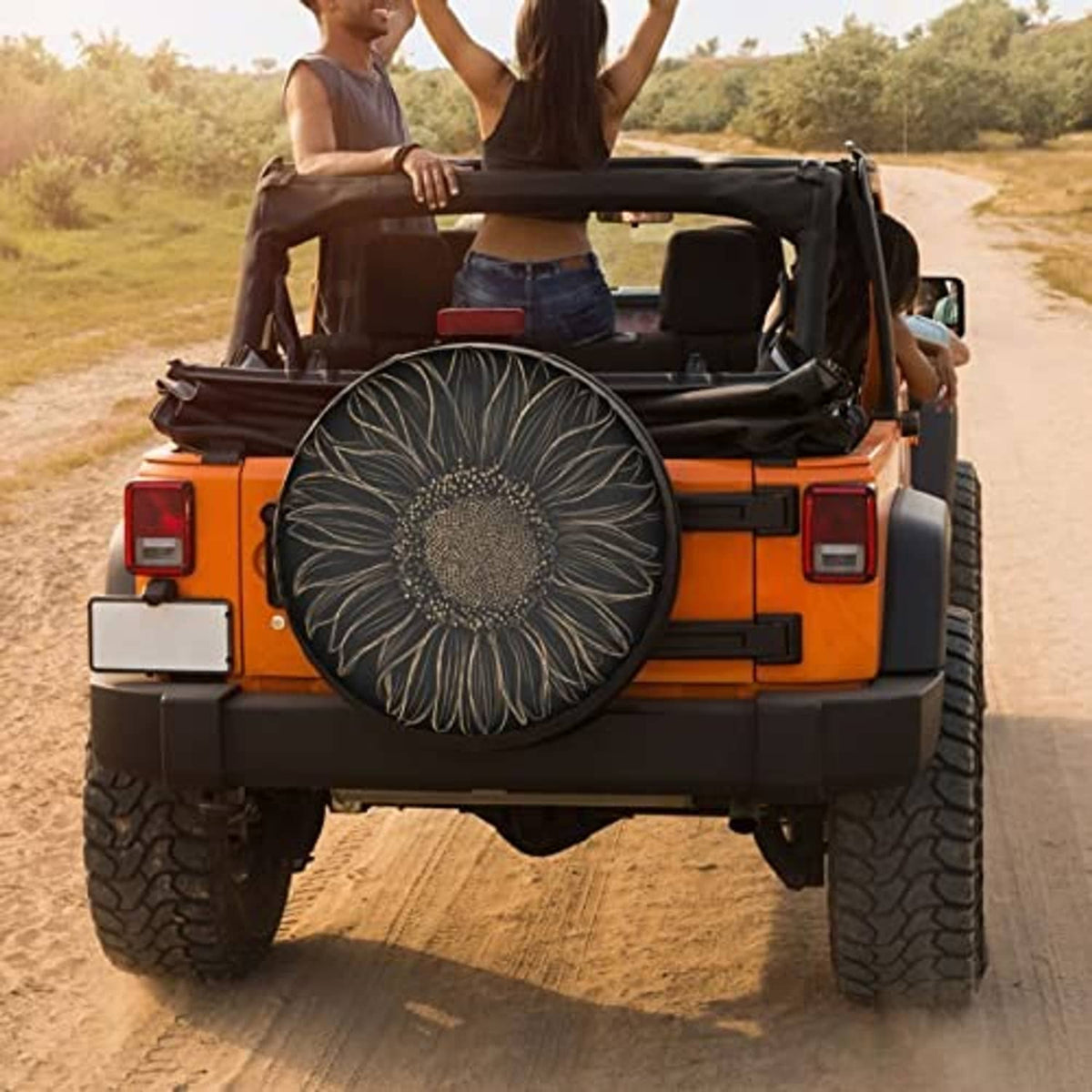 Black spare tire cover with gold sunflower floral design mounted on rear of SUV