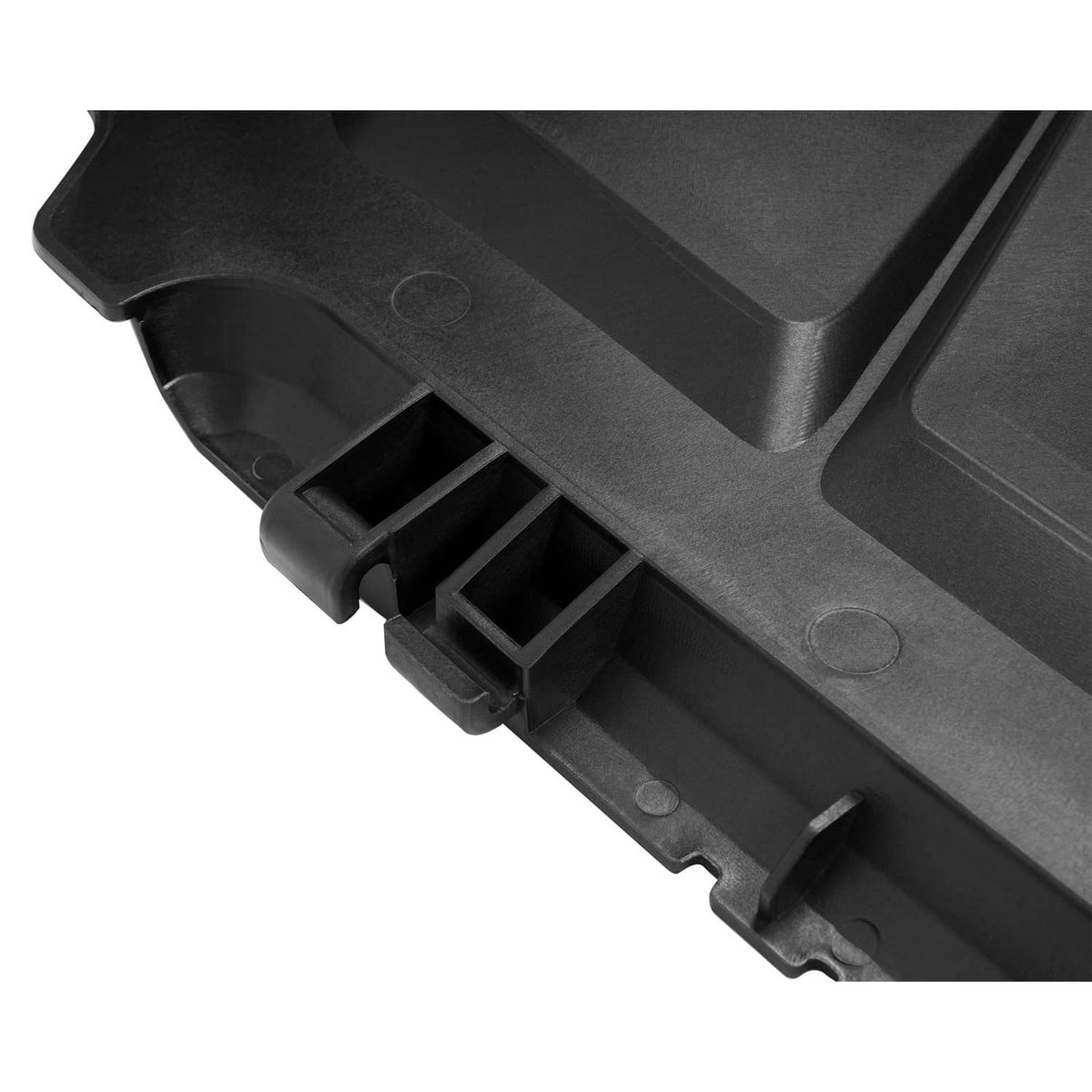 Black discharge chute underside with molded ribs and latch mounting tabs.