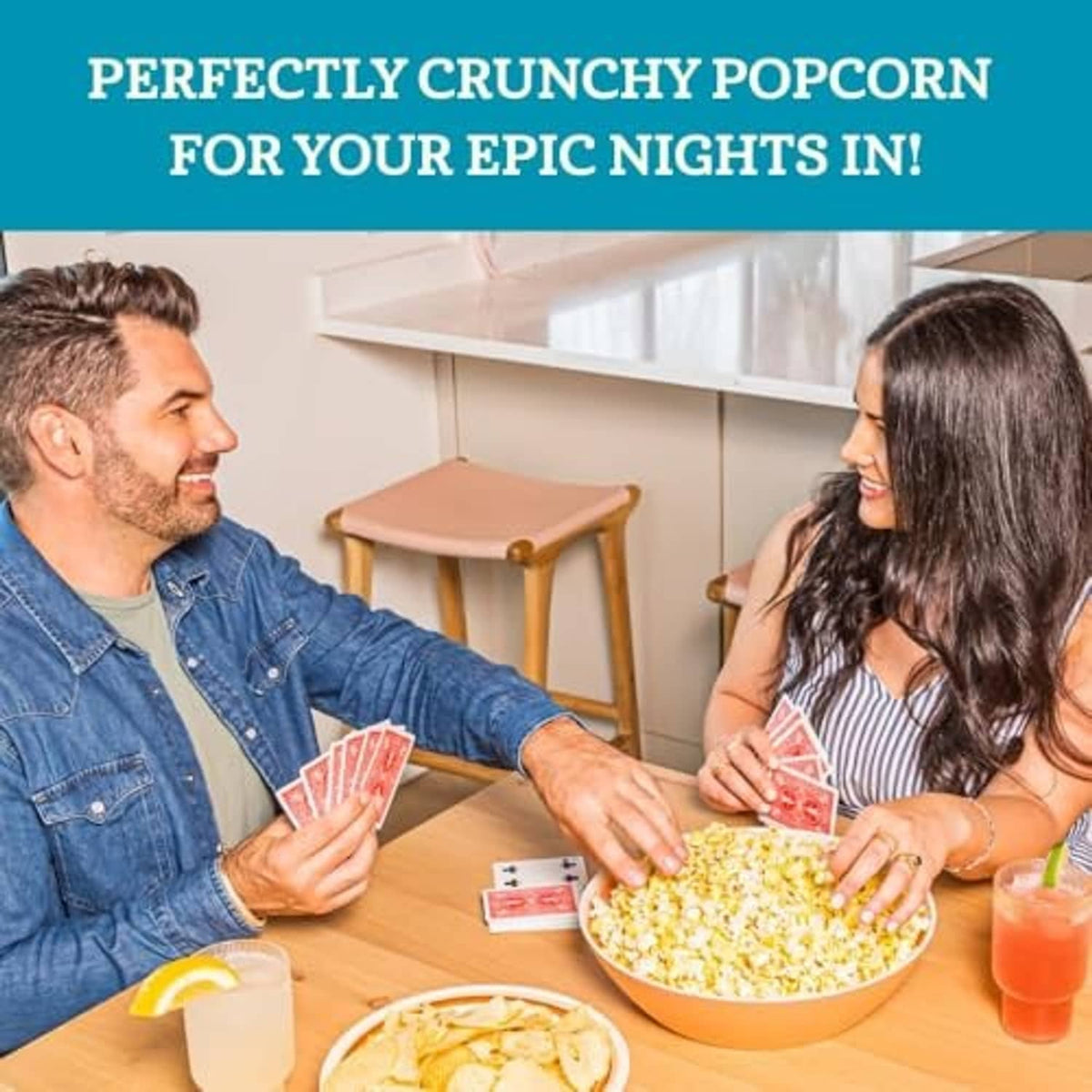 Couple sharing a bowl of popcorn at the table, movie-night snack ready.