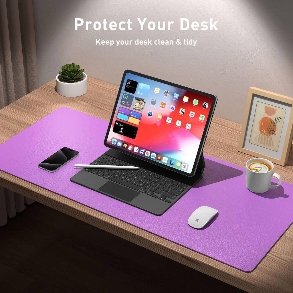 Violet desk pad protector on a wooden desk with laptop, keyboard, and mouse