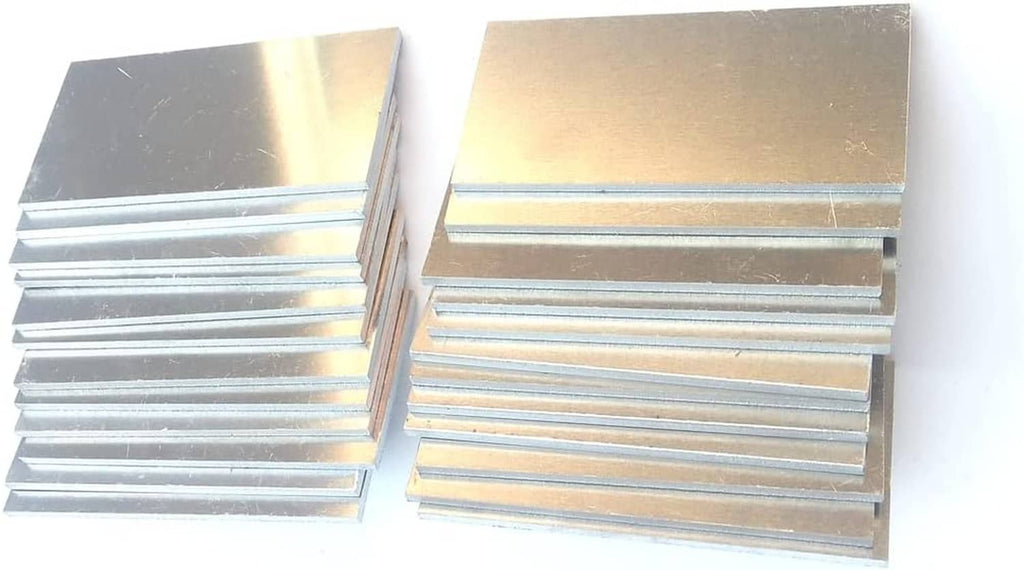 Two stacks of silver aluminum coupon plates with smooth top surfaces and layered sides.