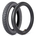 Black 14-inch tire and tube set with angled valve stem and deep tread pattern.
