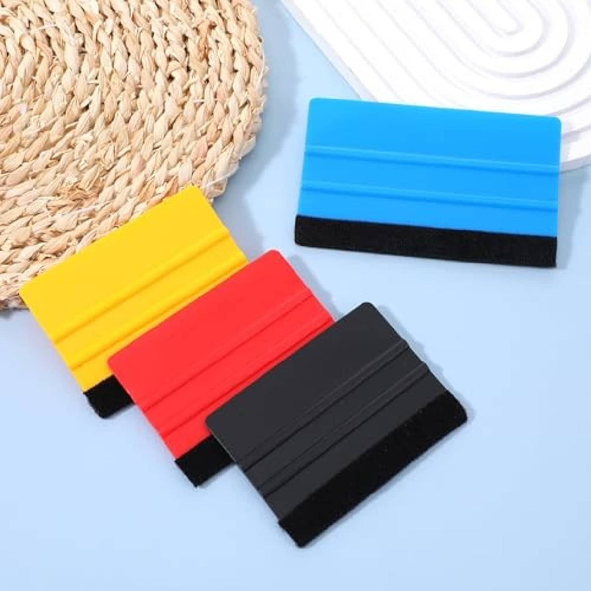 Assorted felt-edge vinyl squeegees in blue, yellow, red, and black with felt tips