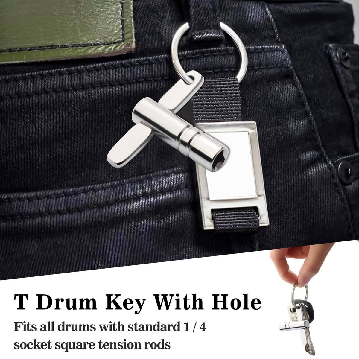 Chrome drum tuning key clipped to a belt loop on dark jeans