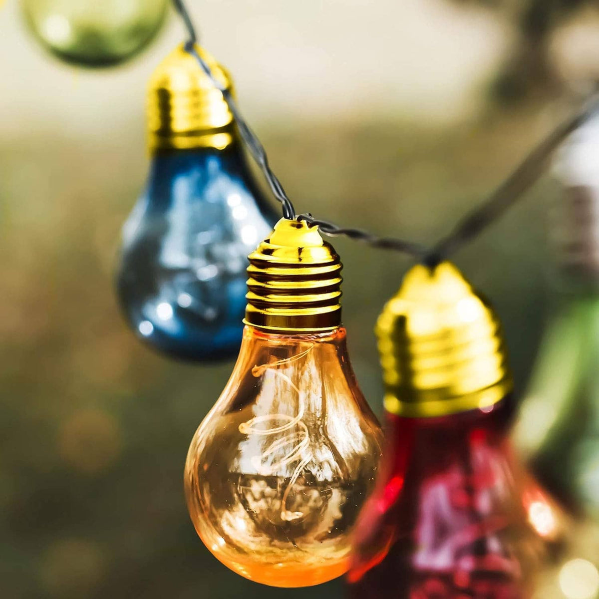 Gold E14 to E12 lamp adapter converter with hanging bulbs in view