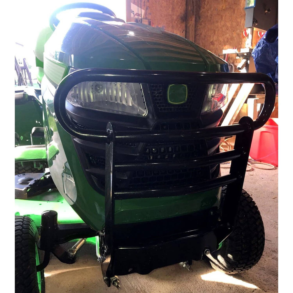 Black brush guard with curved top bull bar installed on front of riding mower