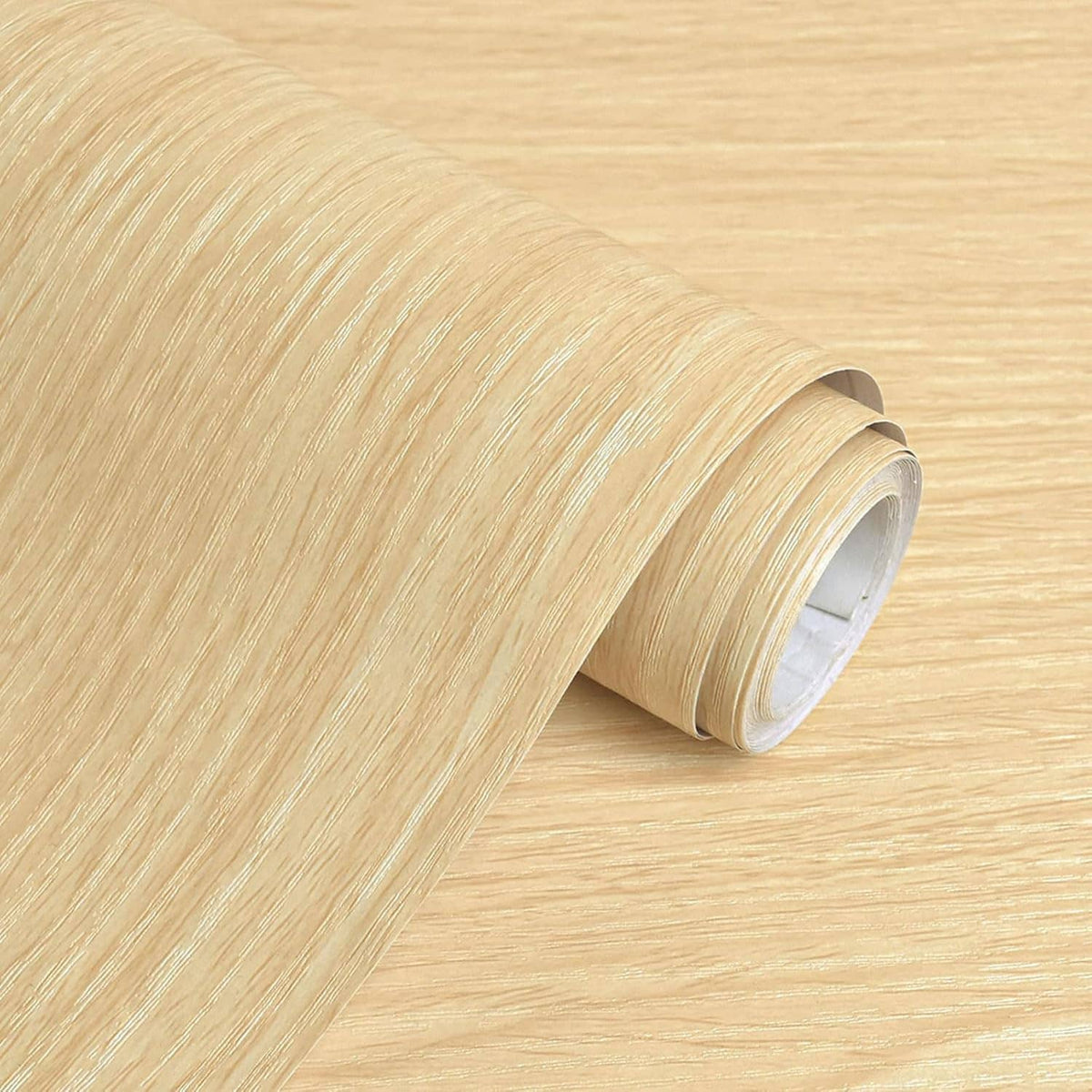Light wood grain contact paper roll close-up with visible inner backing edge