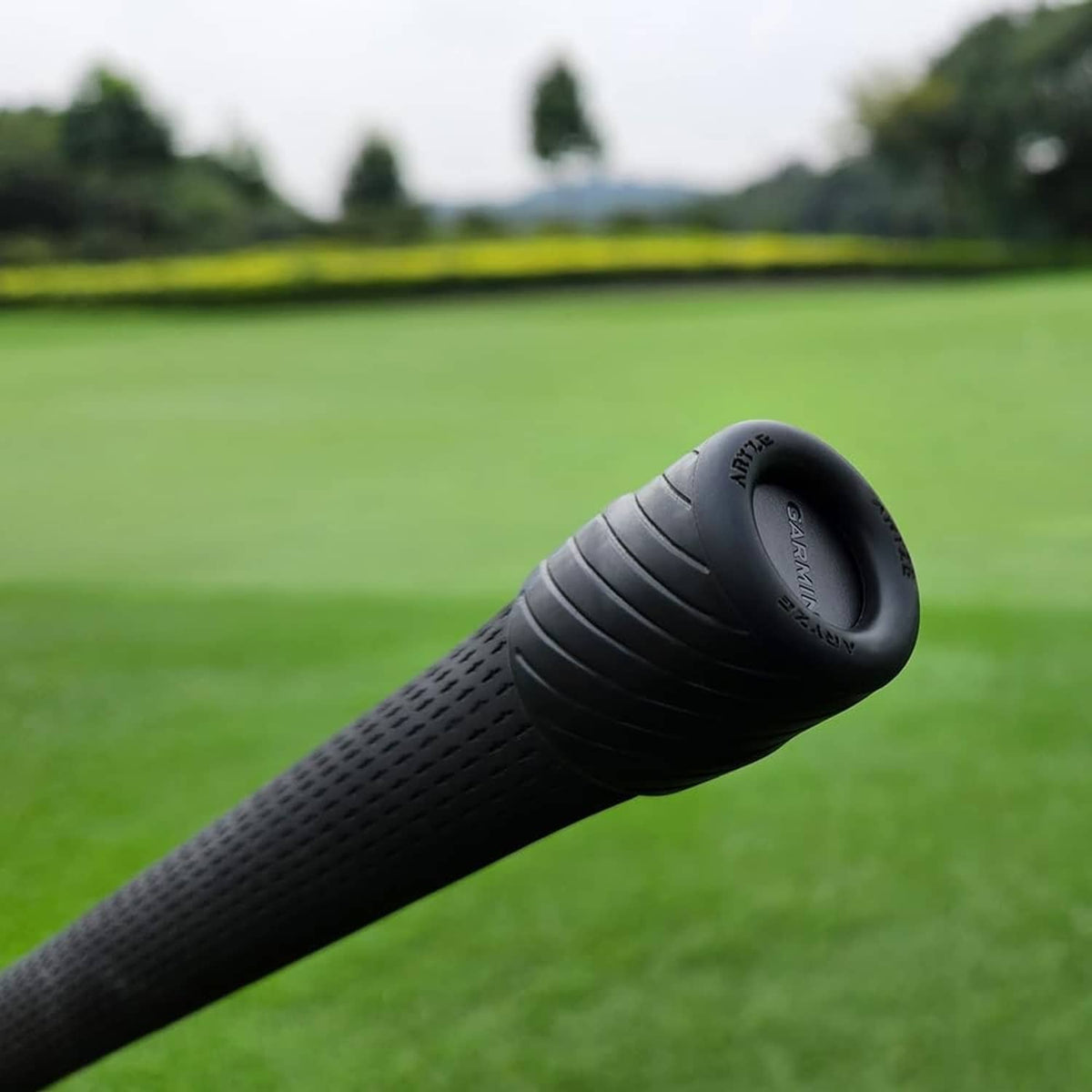 Black golf club sensor cover fitted on club end near sensor opening