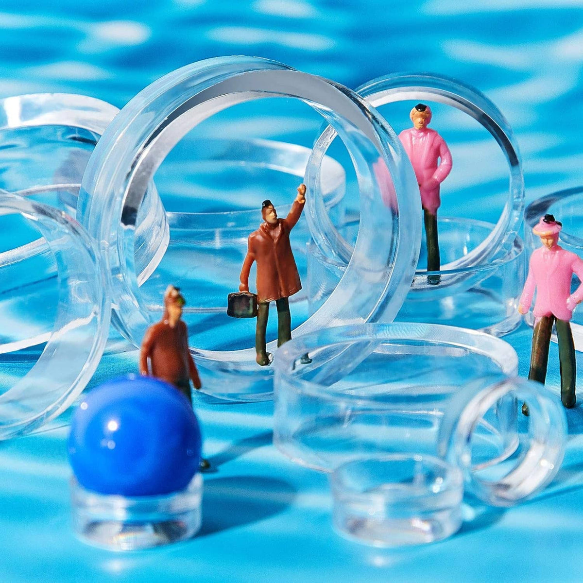 Clear acrylic sphere stand holding a baseball, with extra small ring stands nearby