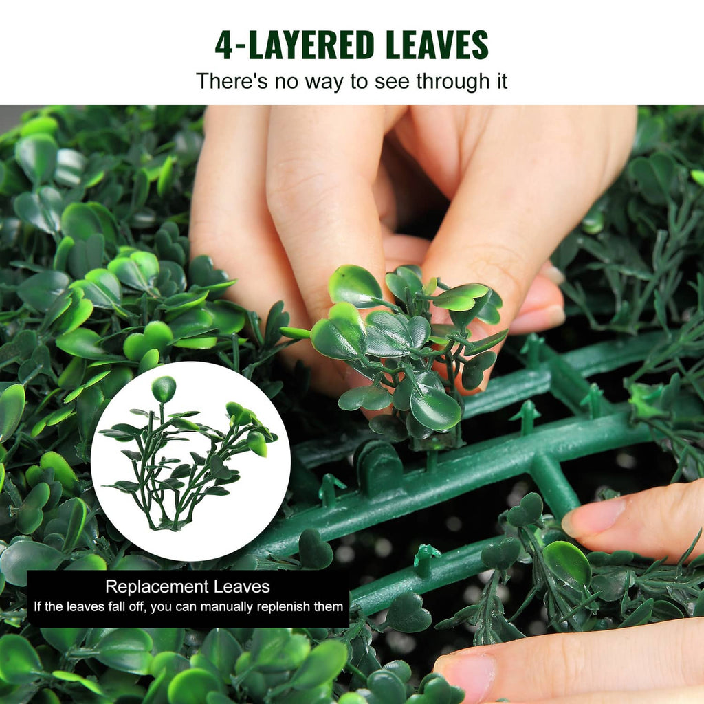 Artificial topiary ball with layered faux leaves, hand-adjustment close-up