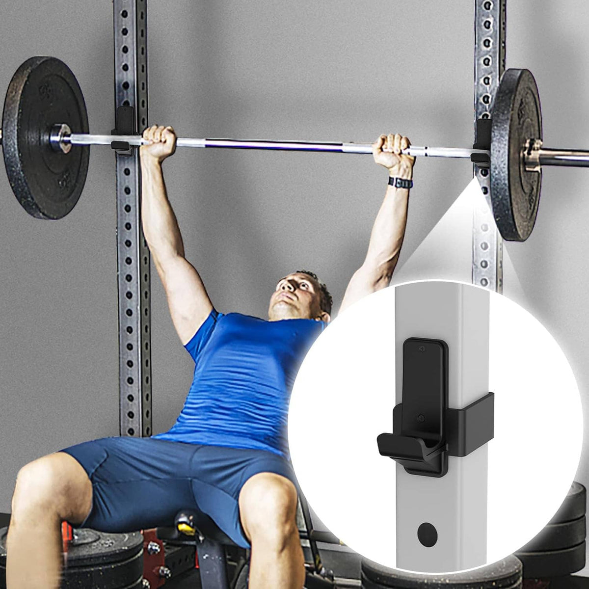 Black J-hooks mounted on a power rack post, holding a bar at the cradle
