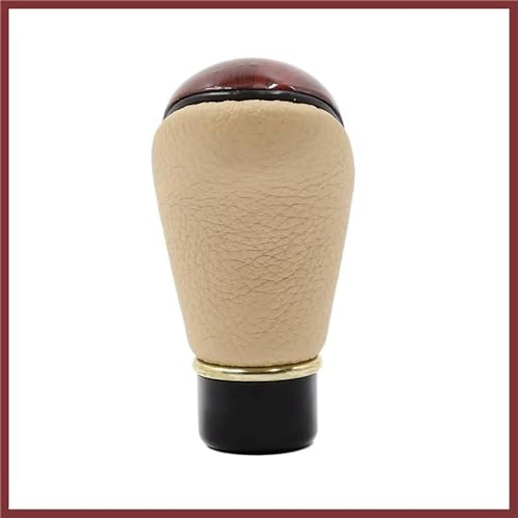 Beige faux leather gear shift knob with gold ring and black mounting base