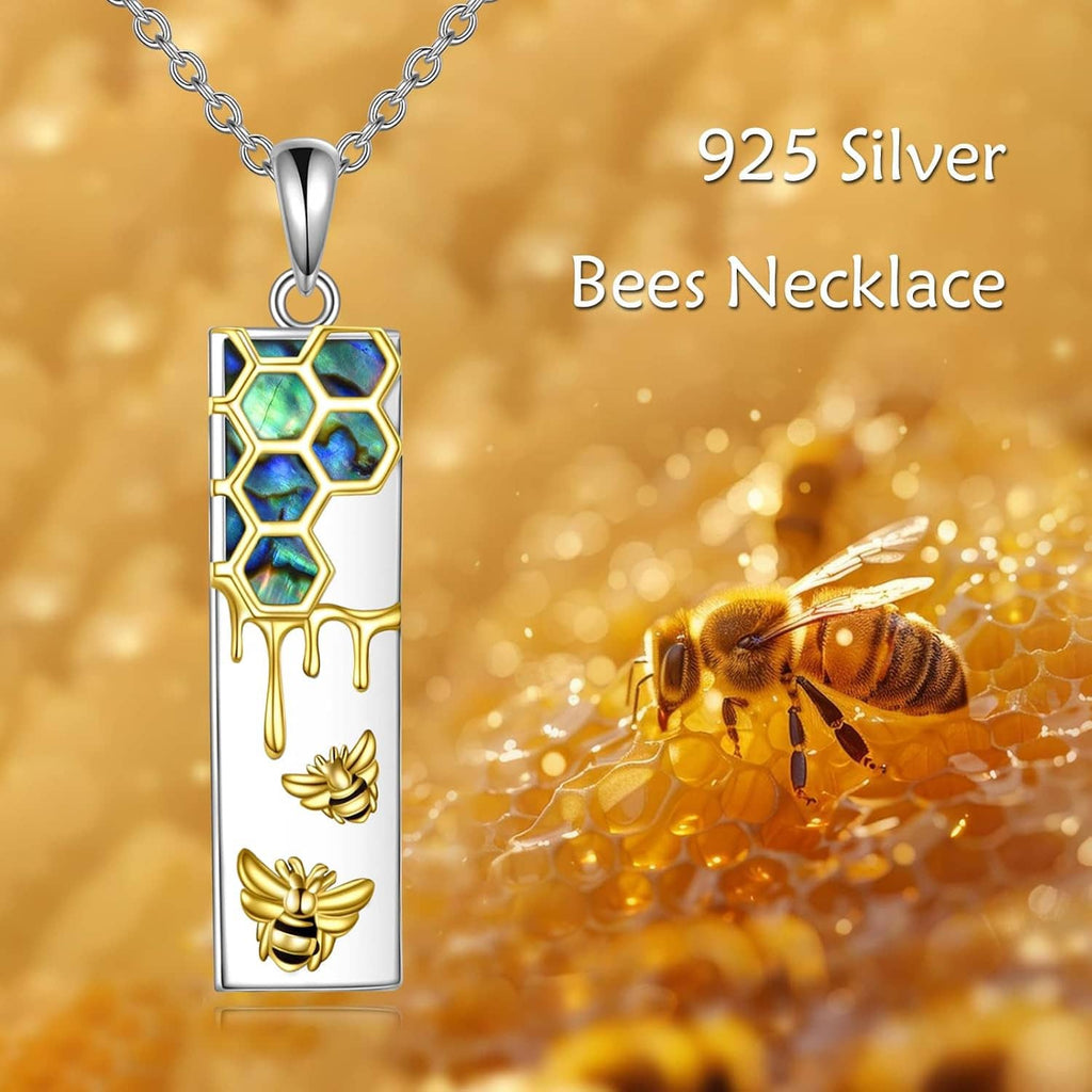 925 silver bees pendant necklace with blue hexagon inset, gold drips, and small bee charms