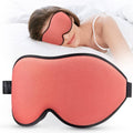 Coral red contoured sleep eye mask with black trim and soft foam edging