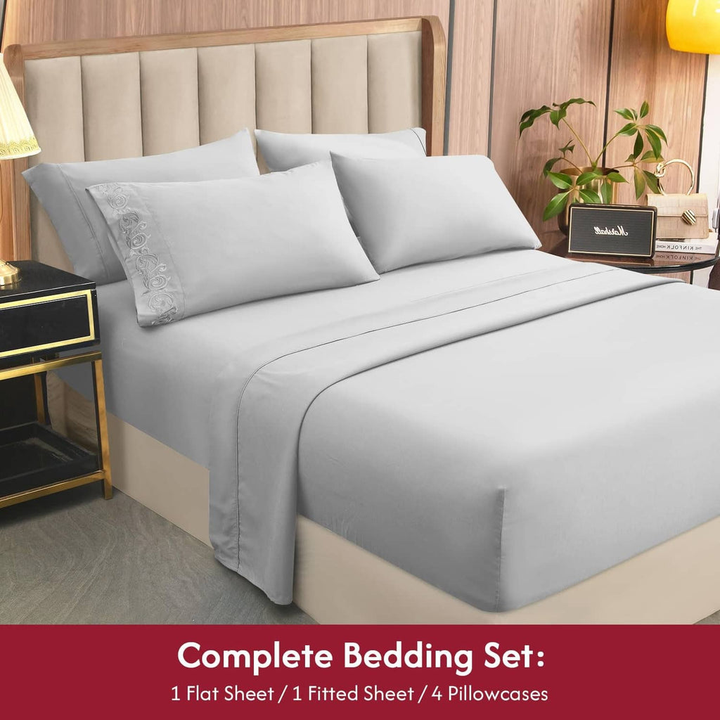 Light gray king sheet bedding set with four pillows and flat sheet top