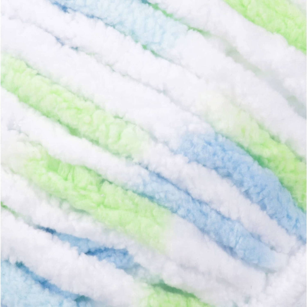 Close-up of pastel super bulky yarn stripes in white, light blue, and pale green bands