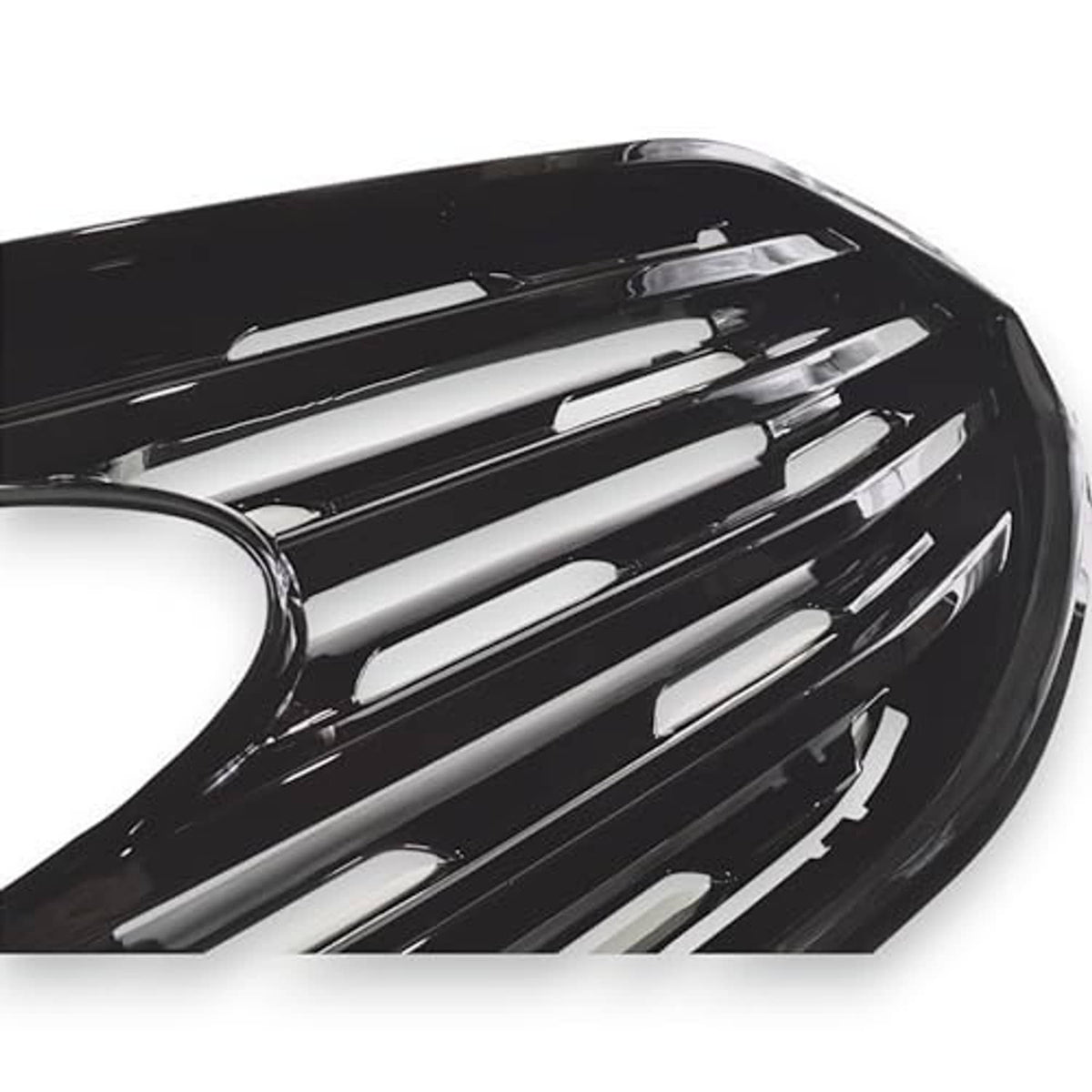 Gloss black grille overlay detail view with chrome-like silver bar inserts and center hole