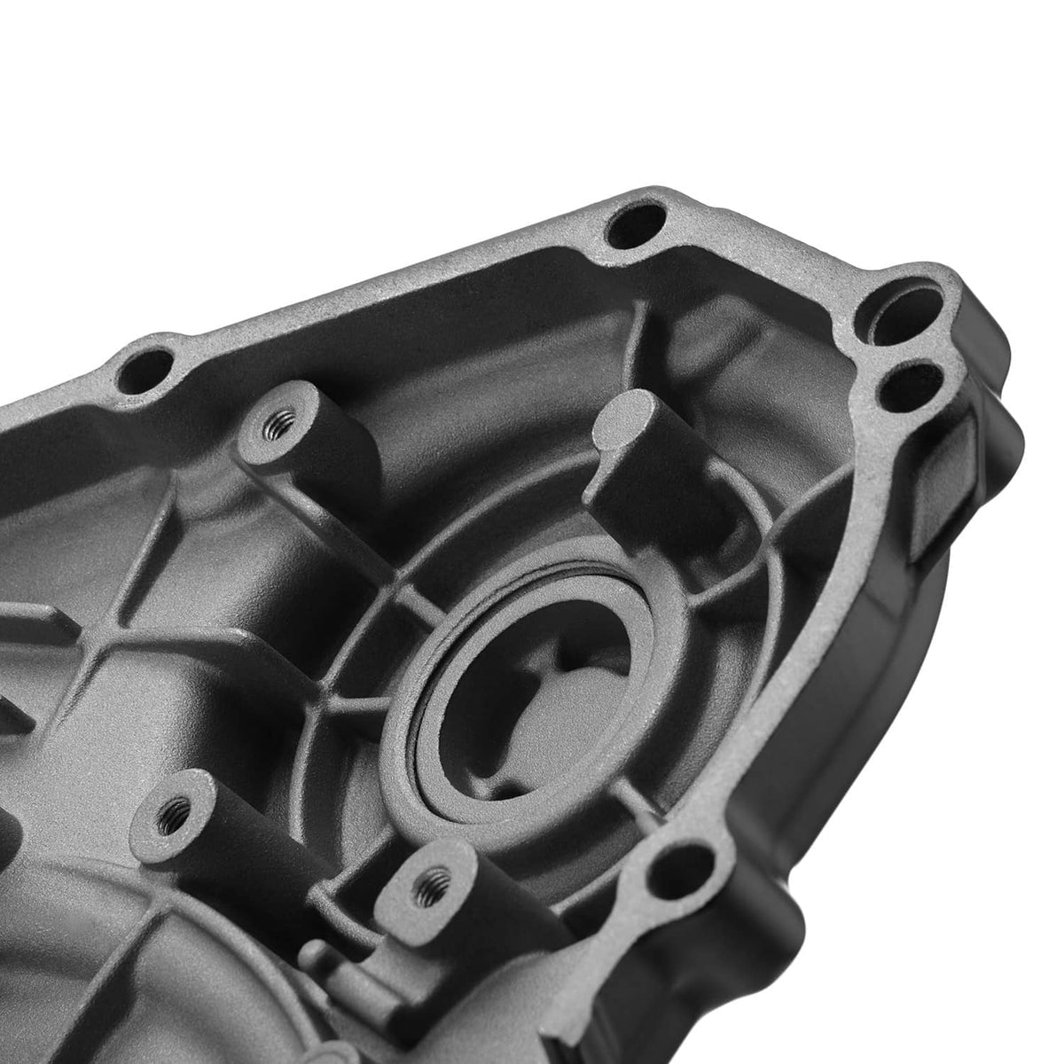 Close-up of aluminum engine cover interior with bolt holes and circular opening