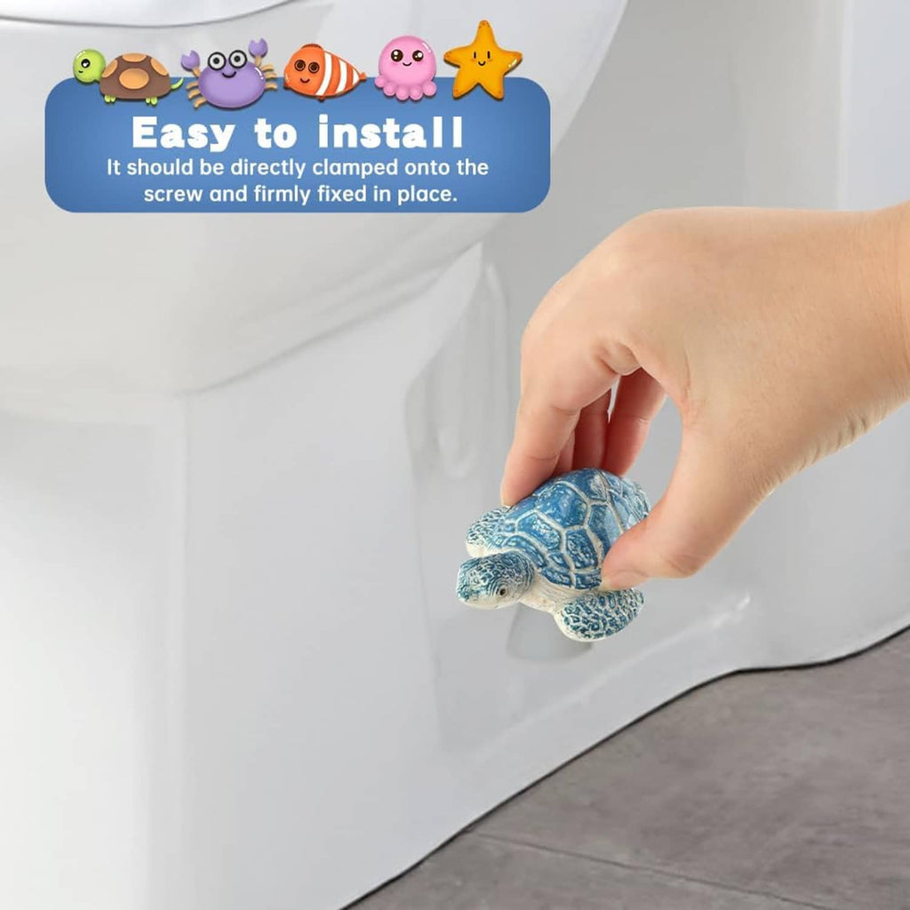 Hand placing blue turtle-shaped toilet bolt cover on a white toilet base