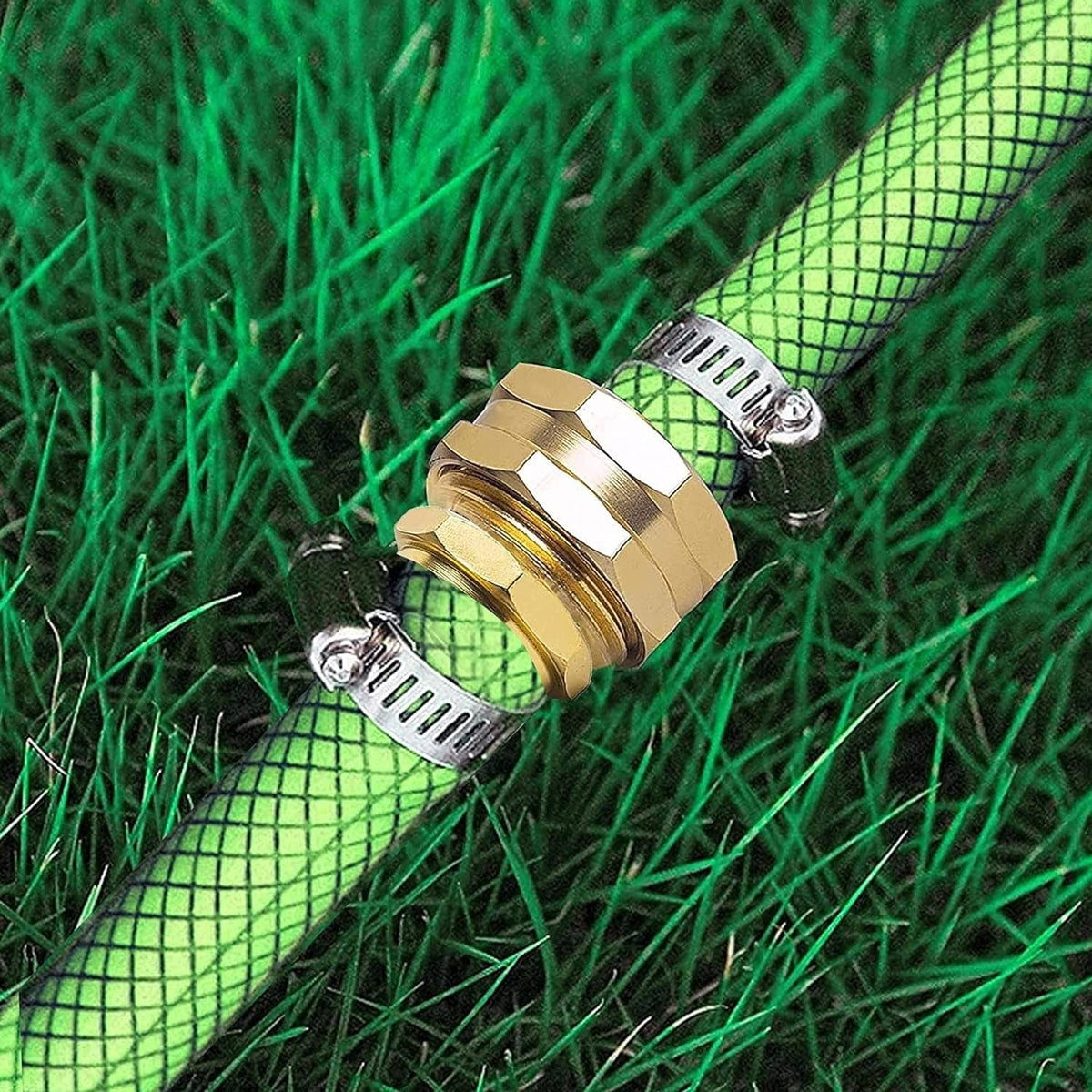 Brass/gold hose connector with metal clamp on green mesh hose, side attachment view