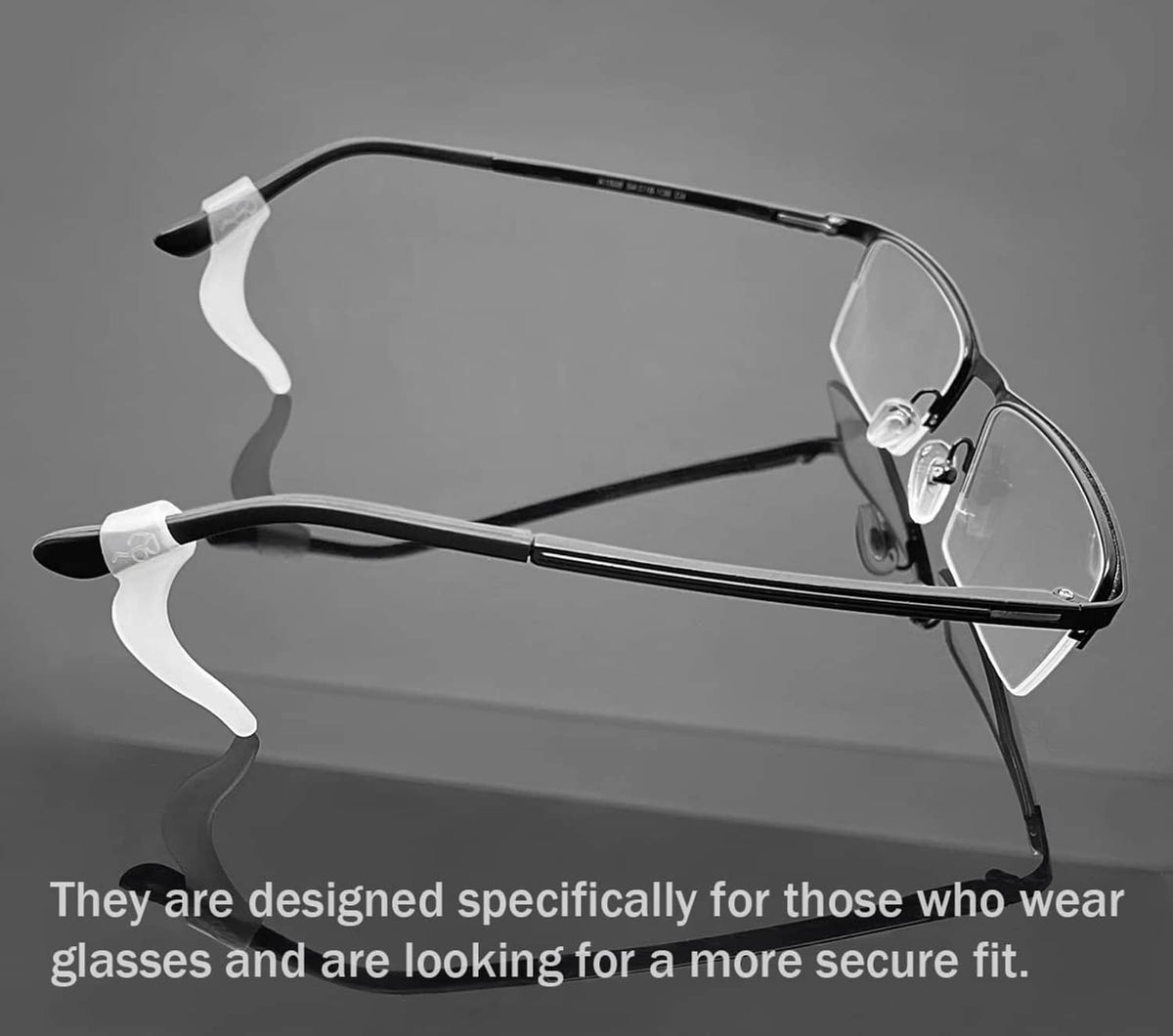 White silicone eyeglass ear hooks attached to metal eyeglass frame, curved fit