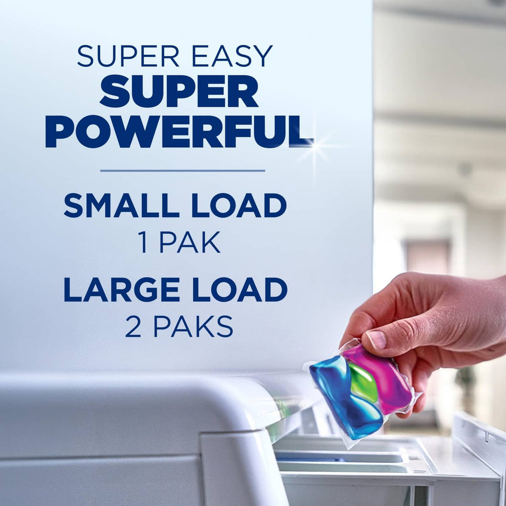 Small-load laundry detergent packet held near a washer drum.