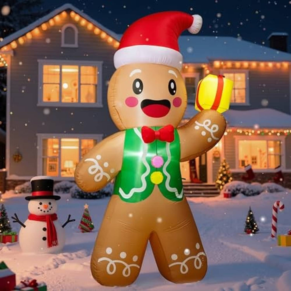 Gingerbread man inflatable with red Santa hat and green icing, holding a yellow gift lantern