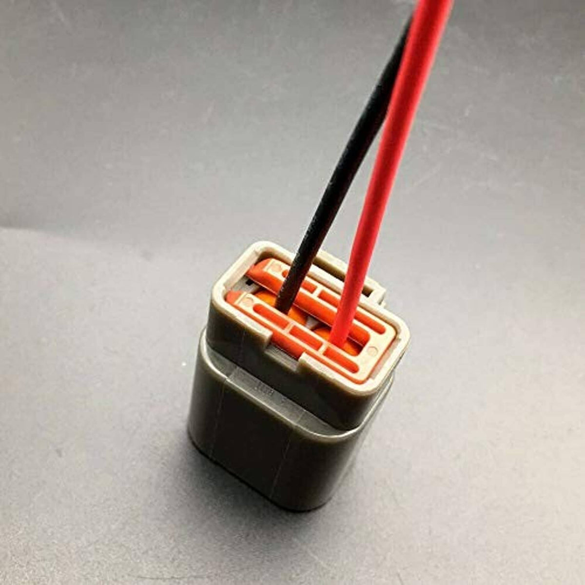 Two-pin pigtail connector with red/black wires and exposed inner terminals