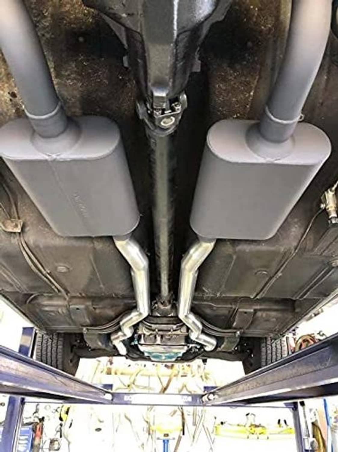 Dual exhaust muffler assemblies with inlet and outlet pipes installed under vehicle