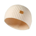 Beige ribbed knit fisherman beanie with folded cuff and FUQILA leather logo patch