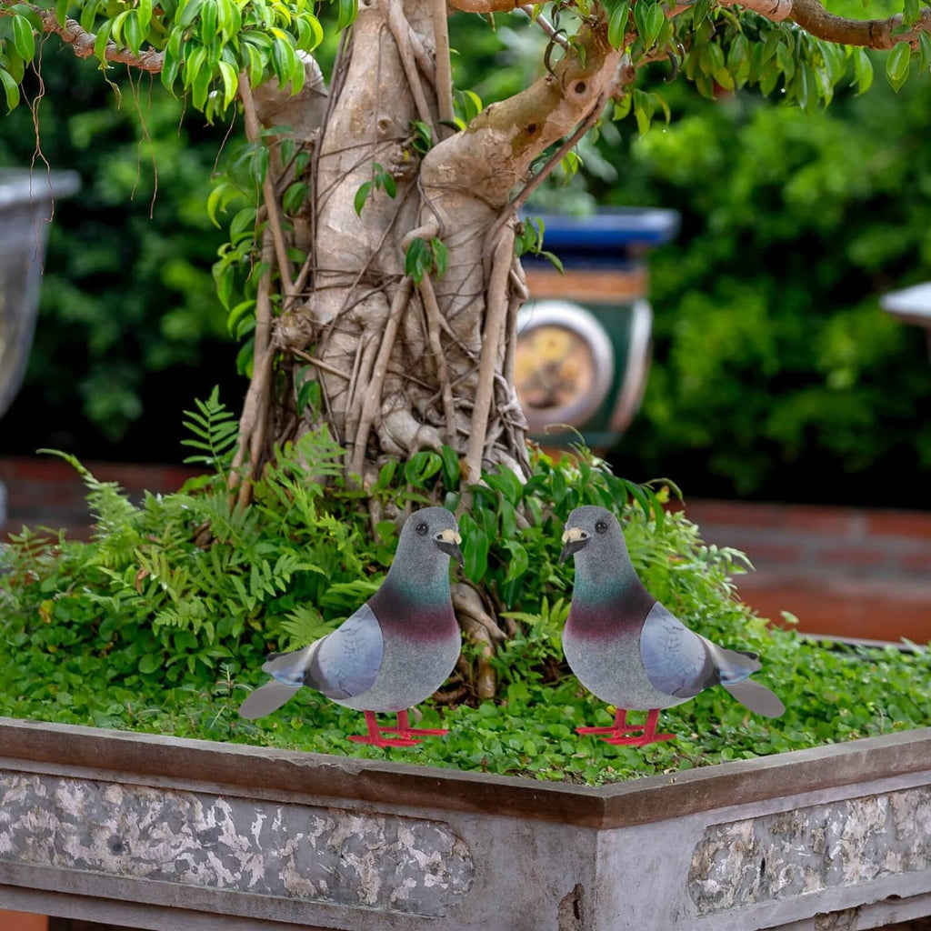 Two foam pigeon figurines with gray teal maroon bodies and red feet