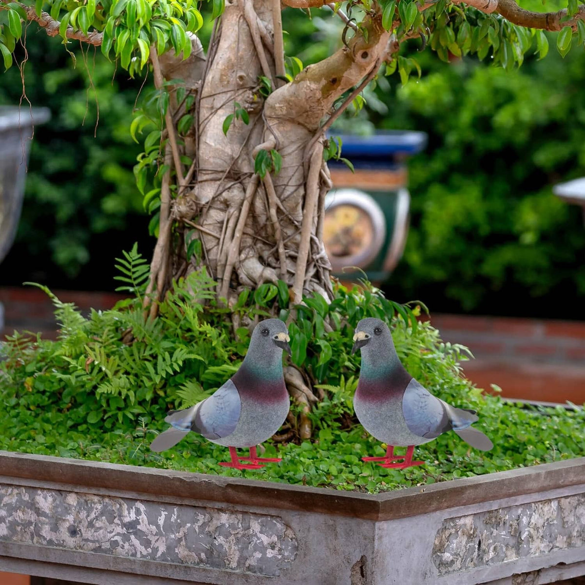 Two foam pigeon figurines with gray teal maroon bodies and red feet