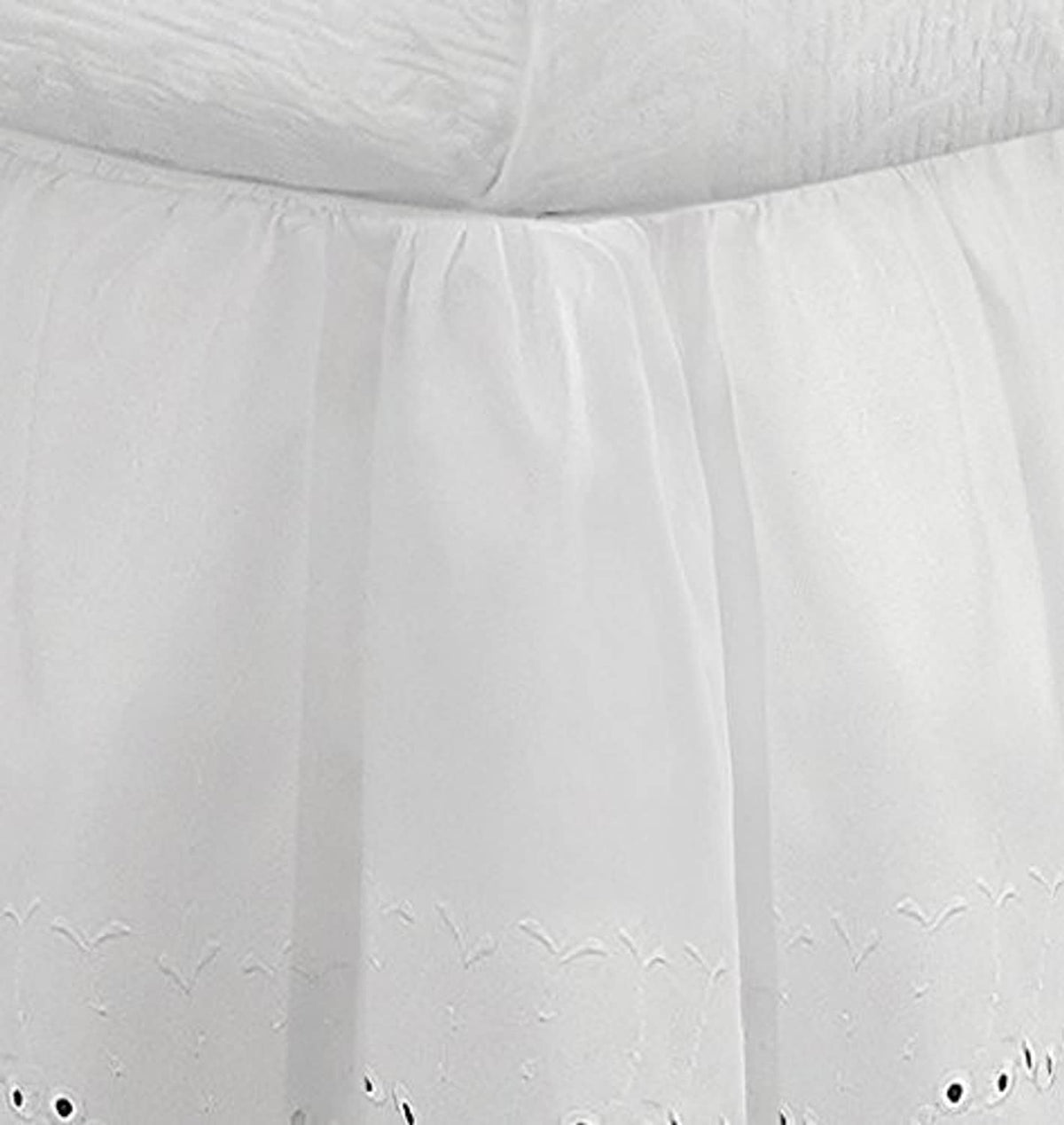 White gathered bed skirt with vertical pleats and small eyelet cutwork at hem