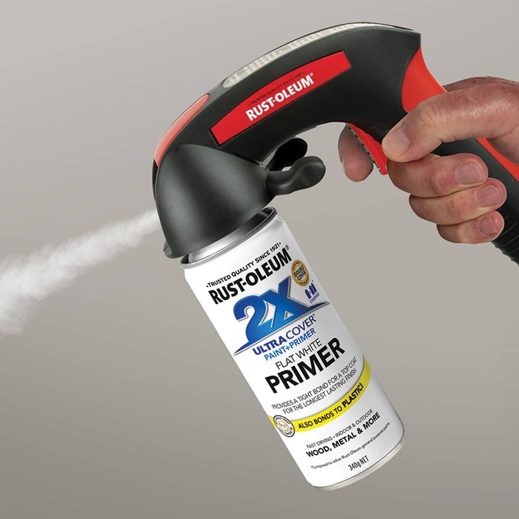 Black and red Comfort Grip spray trigger handle, held in hand