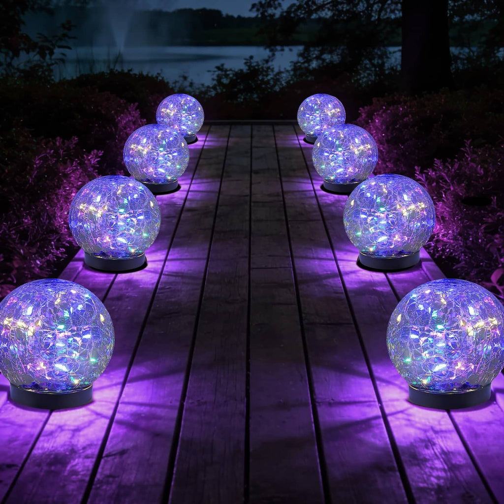 Set of 8 multicolor solar glass globe lights with glowing balls on outdoor path