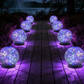 Set of 8 multicolor solar glass globe lights with glowing balls on outdoor path