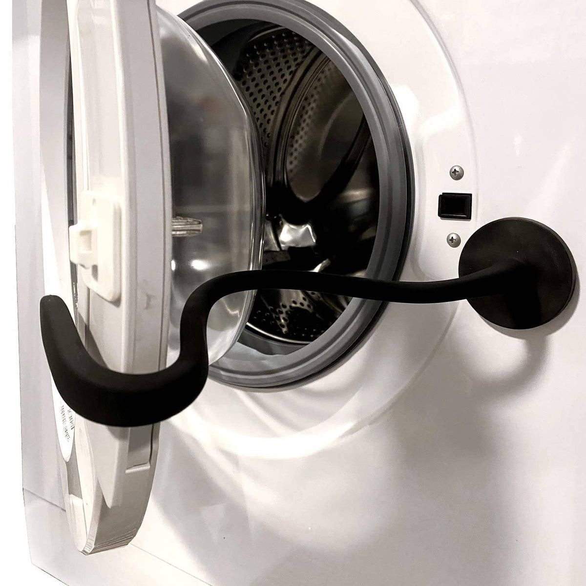 Black magnetic washer door prop positioned on an open front load washer door