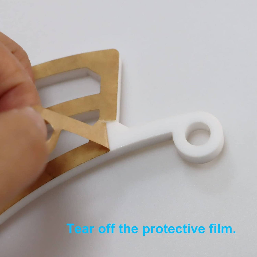 White perch cradle with two screws for mounting, protective film edge visible