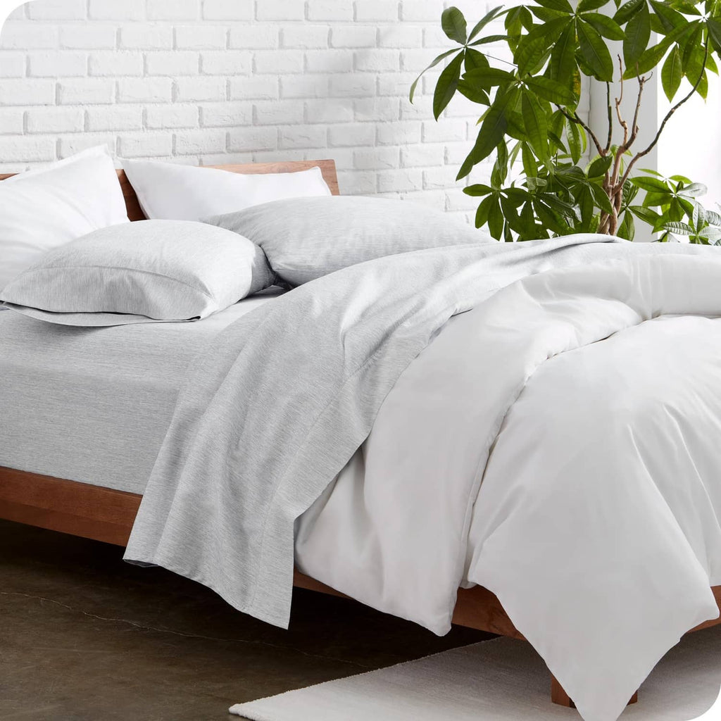 Twin heathered pewter microfiber sheet set on bed with pillowcases and draped flat sheet