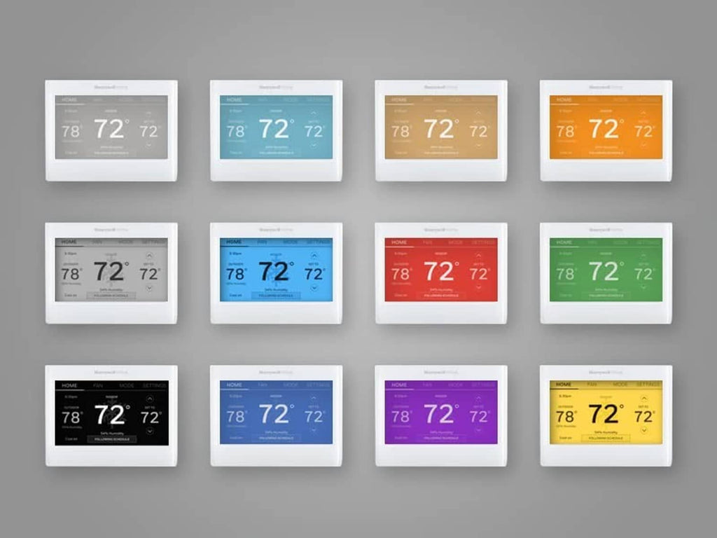 Set of smart color thermostats with multiple colored faceplates and teal home screens.