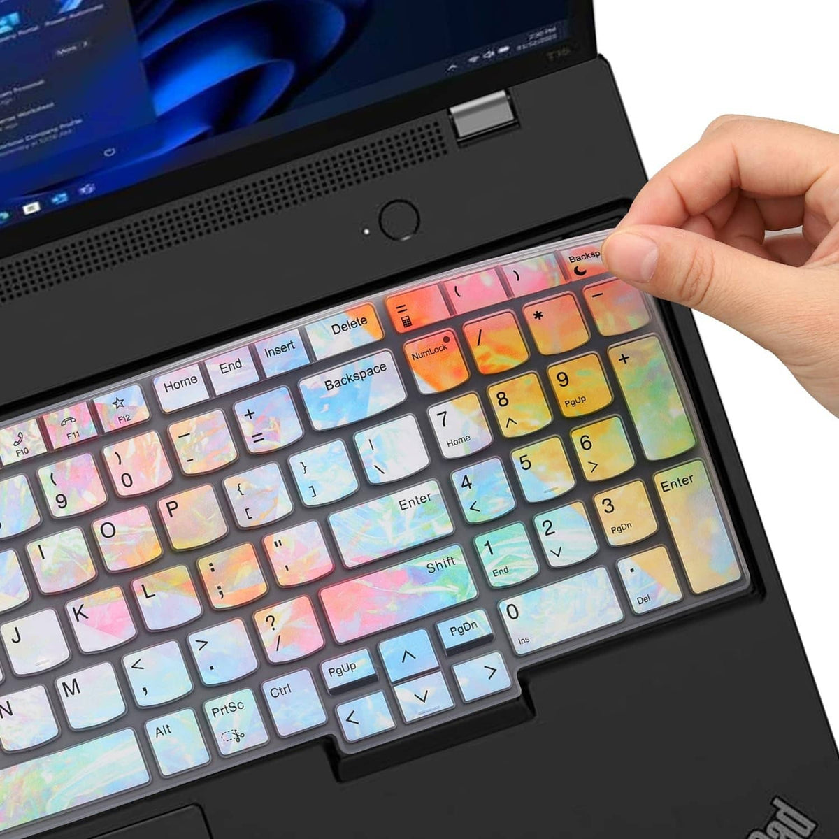 Iridescent keyboard cover being placed over a laptop keyboard by a hand