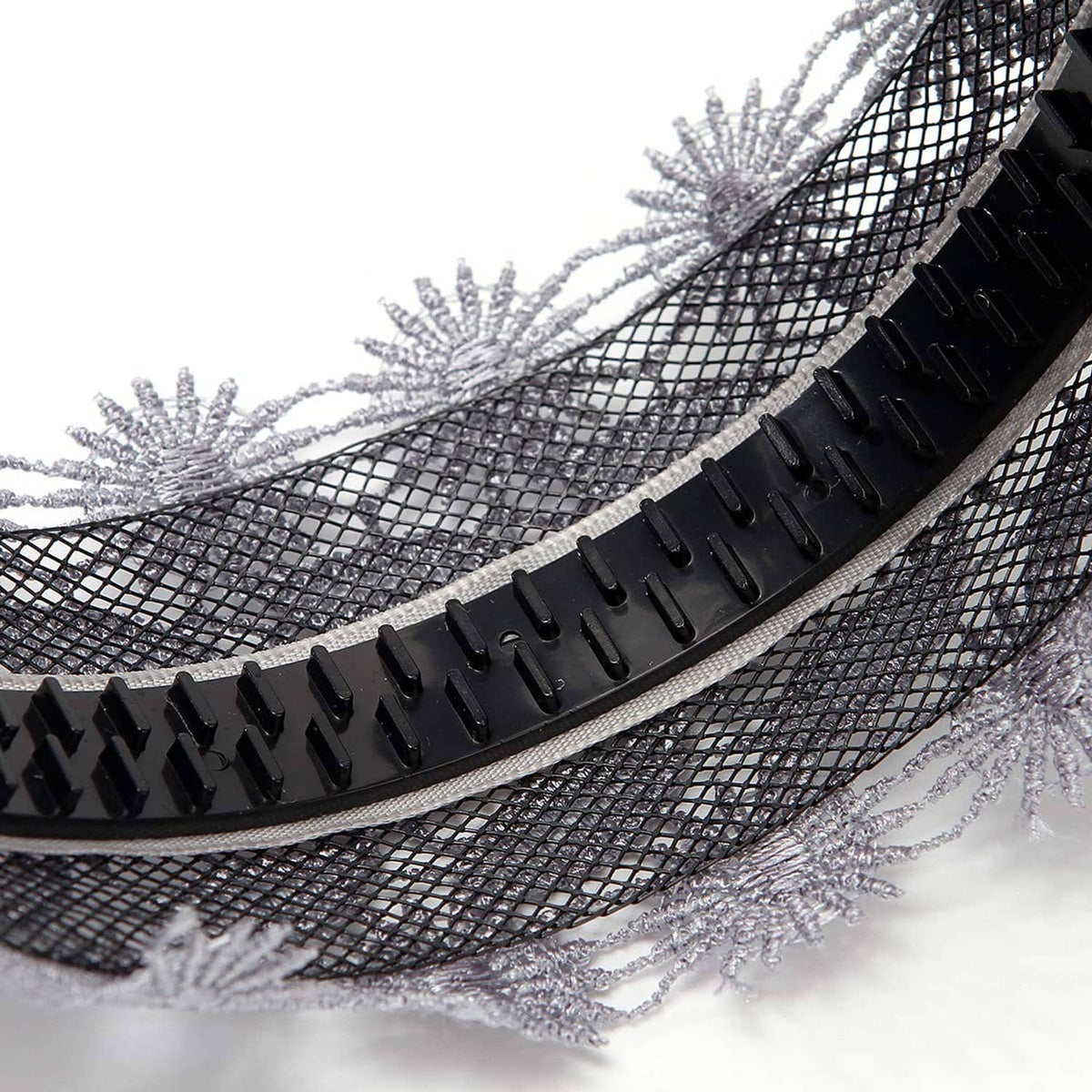 Close-up of silver-gray lace headband with black rubber non-slip teeth strip