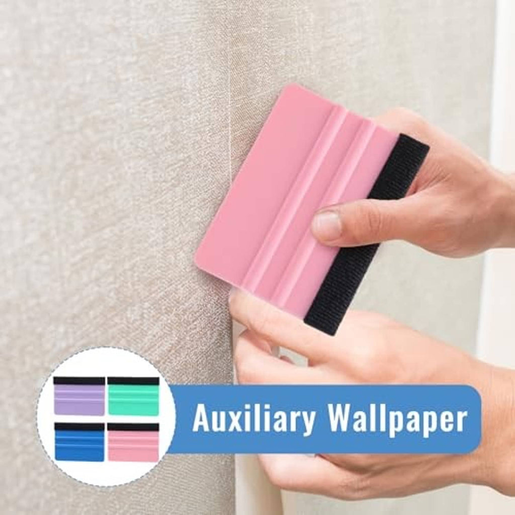 Hands holding a pink felt squeegee tool pressing onto a textured wall