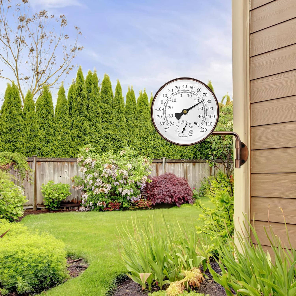 Brass swivel thermometer on an outdoor wall, round dial with C/F temperature and humidity