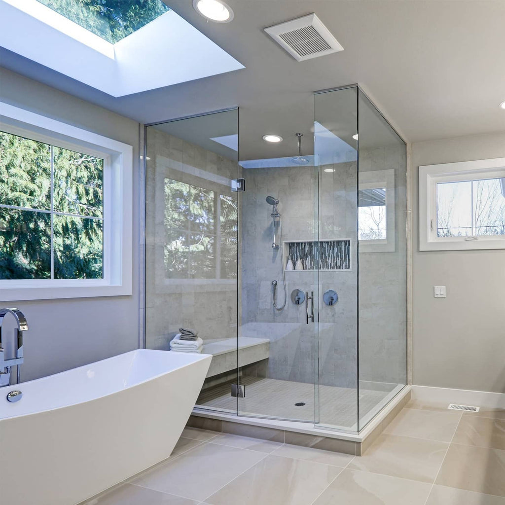 Brushed nickel shower trim controls with round handles in shower enclosure