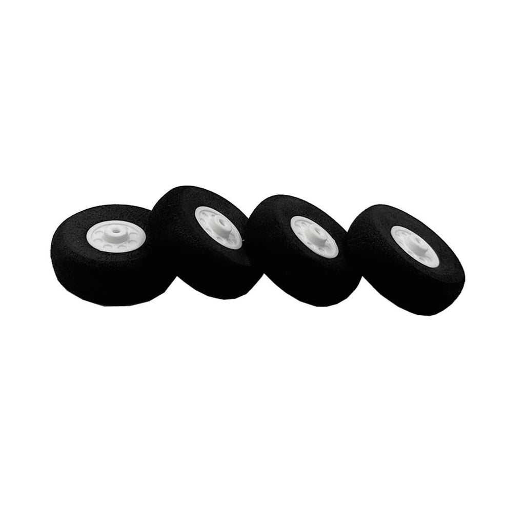 Four black foam RC airplane wheels, white hub faces visible