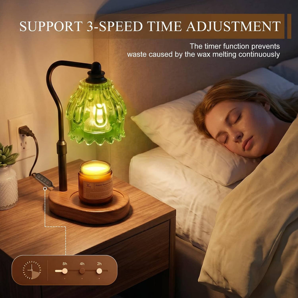 Flame-less candle warmer lamp with green glass shade on black stand, on bedside table.