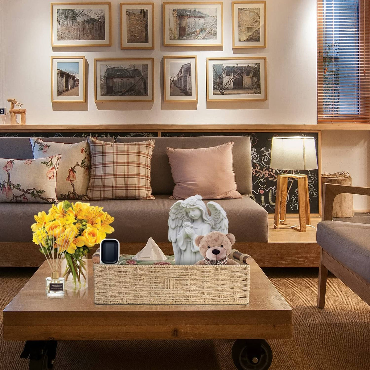 Beige woven paper rope storage basket with two rope handles, open-top on living room table.