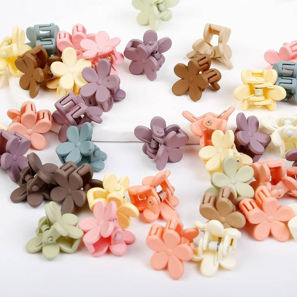 Close-up of mini flower claw hair clips in mixed colors with flower-shaped fronts