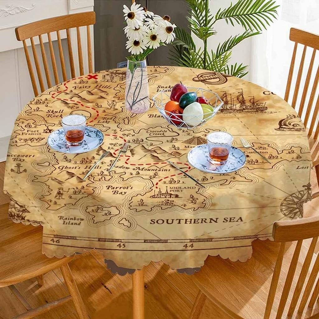 Round map-pattern tablecloth with scalloped hem on a dining table, four chairs